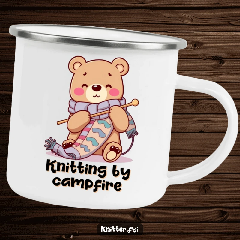 Funny camping mug with a cheerful bear character knitting a long scarf, perfect for outdoor knitting enthusiasts.