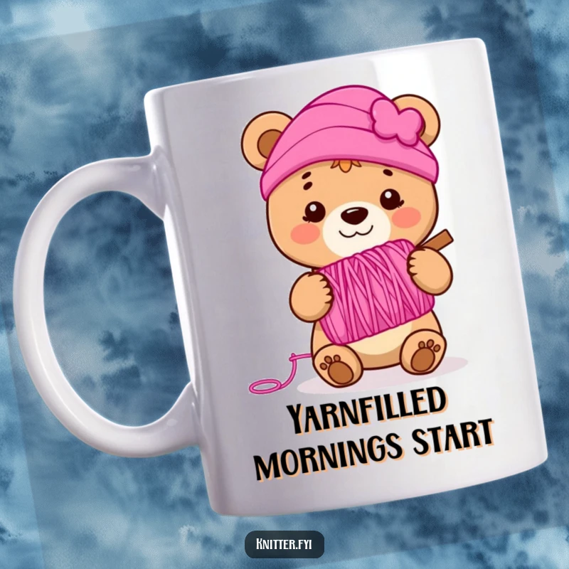 Funny bear cub mug holding a spool of vibrant pink yarn, smiling cheerfully, perfect for knitters and crafters.