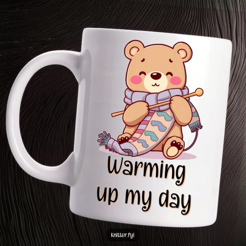 Funny mug with a cheerful bear character knitting a long, vibrant scarf using oversized needles, embodying cozy crafting.