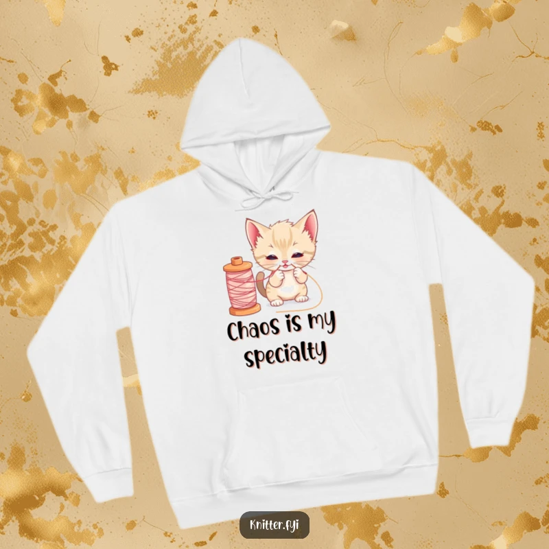 Funny kitten sewing hoodie showing a cute cat pulling a loose thread from a big spool, ideal for cold days and crafters.