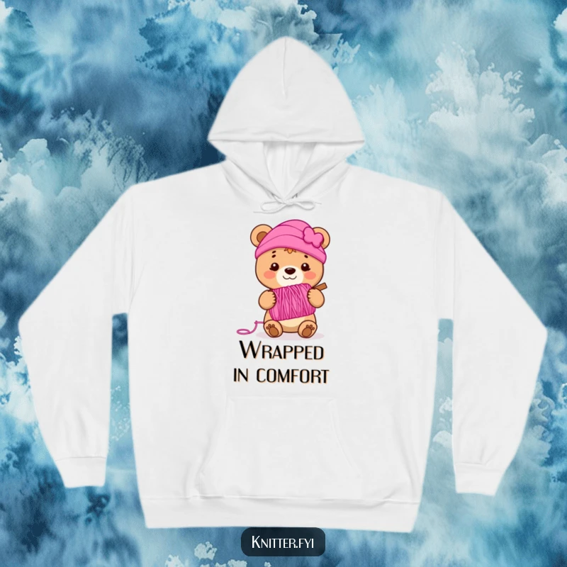 Funny bear cub hoodie holding a spool of vibrant pink yarn, smiling happily, offering cozy and humorous apparel.