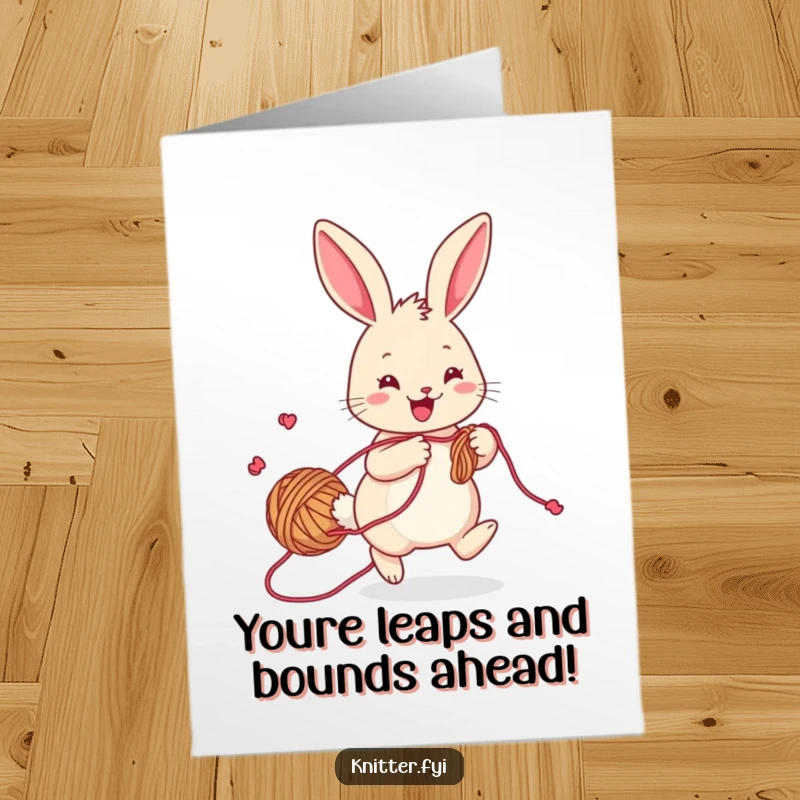 Funny free printable congratulations card of a cheerful rabbit with yarn trailing, hopping playfully while knitting.