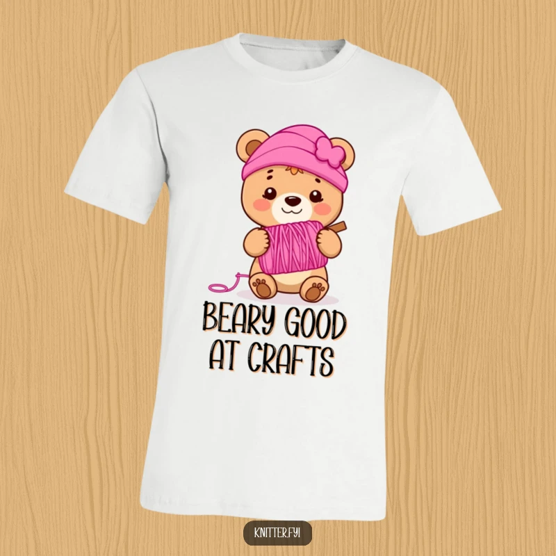 Funny bear cub t-shirt holding a spool of vibrant pink yarn, smiling joyfully, a humorous and cute wearable for knitters.