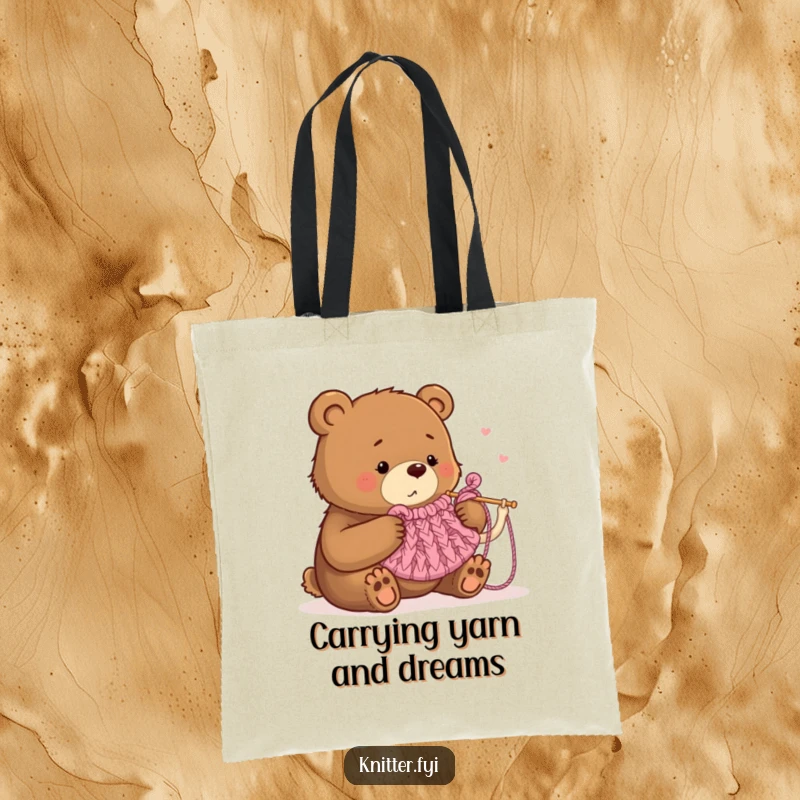Funny tote bag showing a bear humorously struggling to knit a tea cozy with oversized needles, great for carrying supplies.